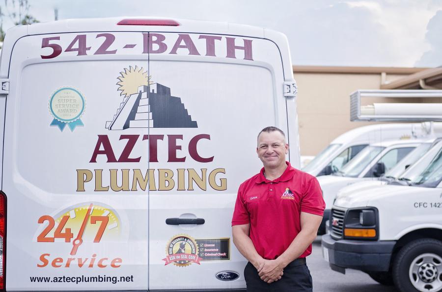 Aztec Plumbing & Drain plumber in front of truck