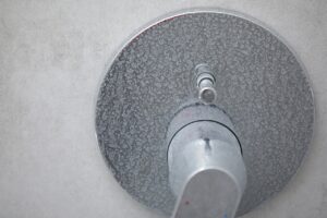 Limescale and soap scum build up on shower due to hard water